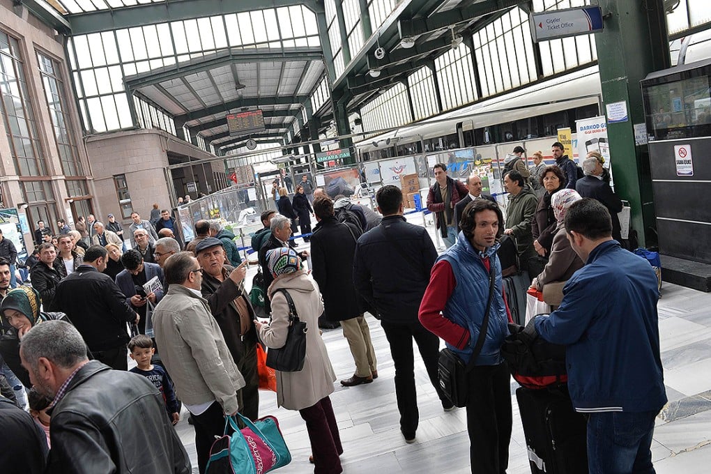 People wait at a train station in Ankara after a massive power cut. Photo: AP