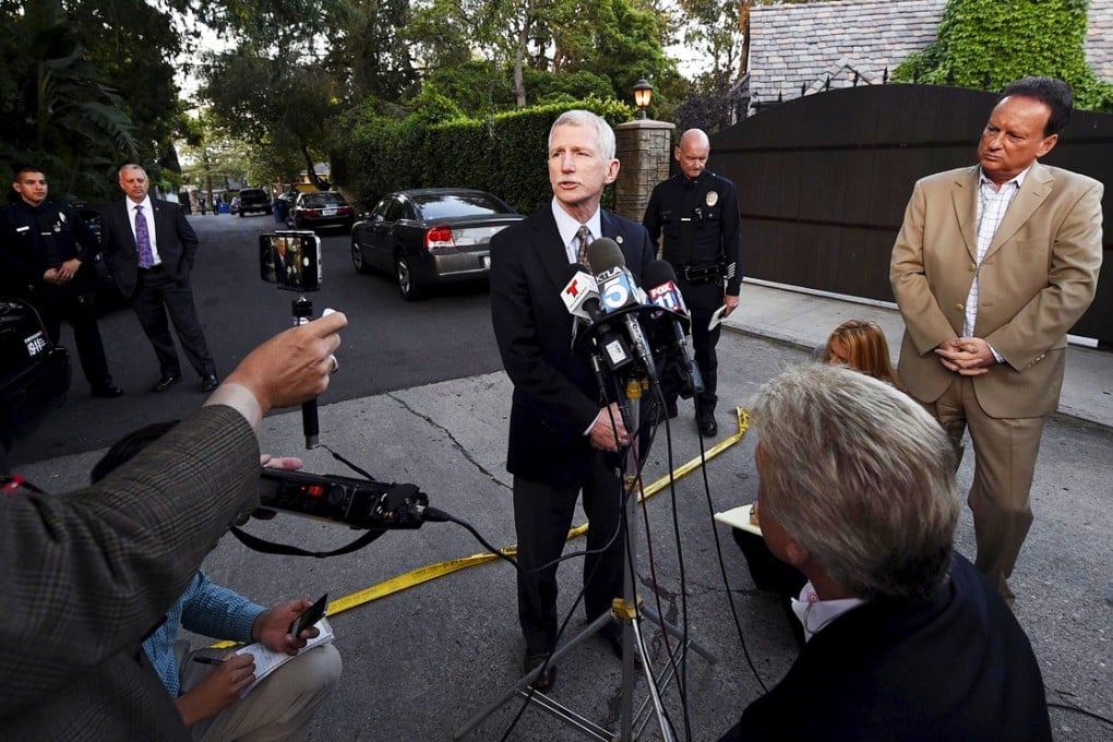 LAPD captain William Hayes briefs the media outside Andrew Getty's house after the oil heir was found dead in the bathroom of his mansion. Photo: Reuters
