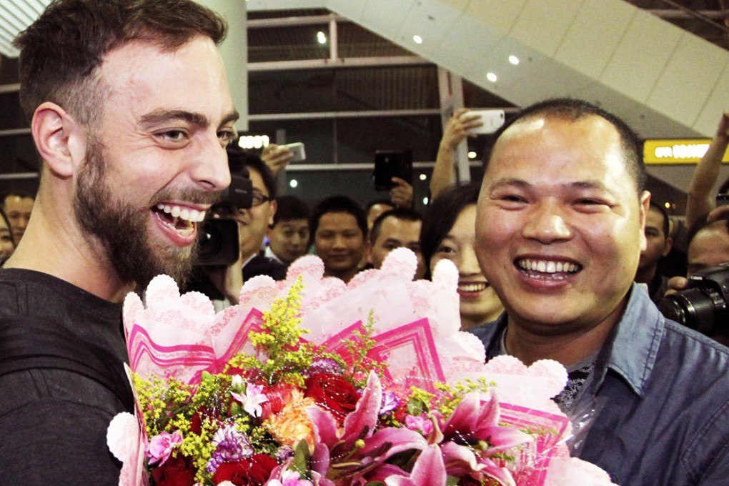 BuzzFeed writer Matt Stopera, left, is greeted on arrival at Jieyang Chaoshan International Airport by Li Hongjun (Brother Orange). Photo: SCMP Pictures