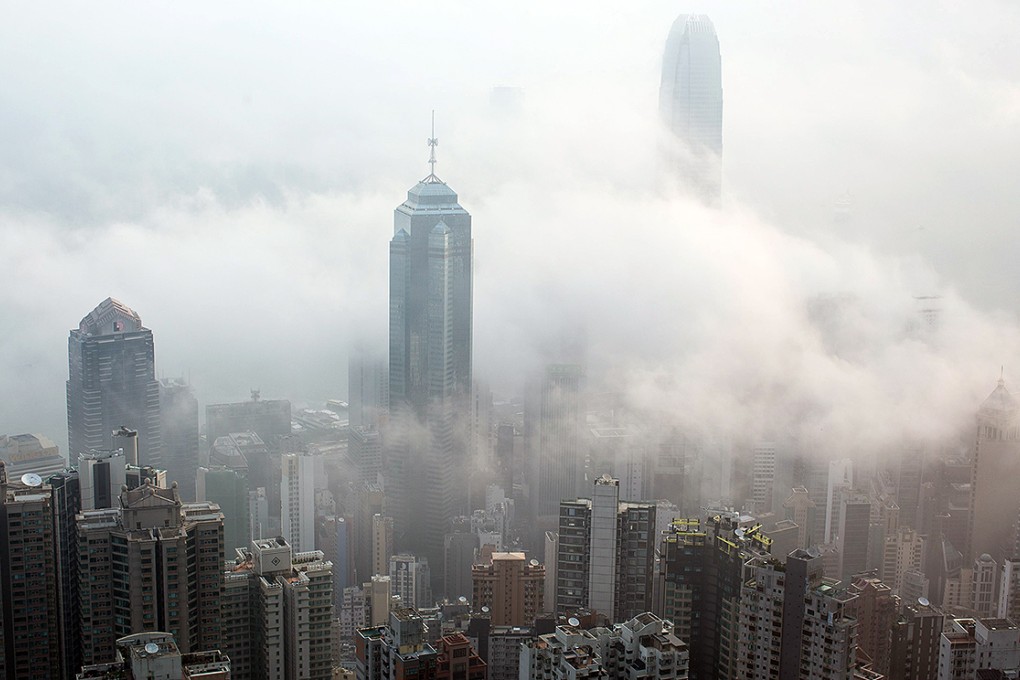 Fog brought on by a humid maritime airstream shrouds residential and commercial buildings on Hong Kong Island. Photo: EPA