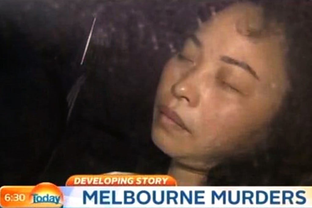 Cai Xia Liao, 45, is pictured in the back of a police car, in this scene shot by Australia's Nine News. Photo: Nine News