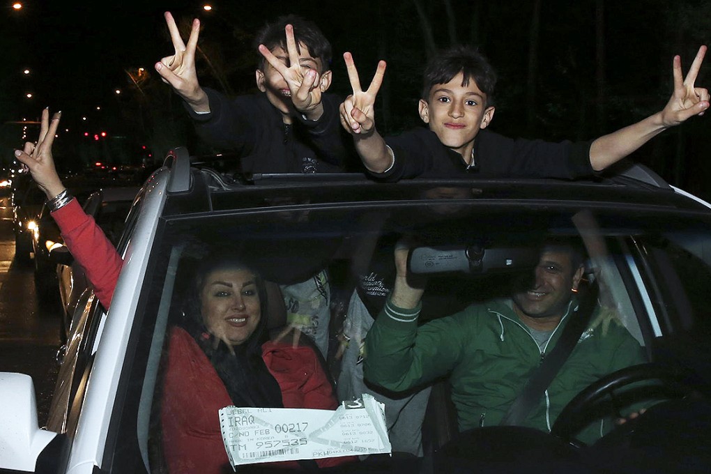 Iranians flash victory signs while celebrating nuclear deal. Photo: AP