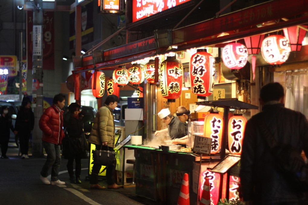 Street eats: food stalls along Dotonbori Canal.