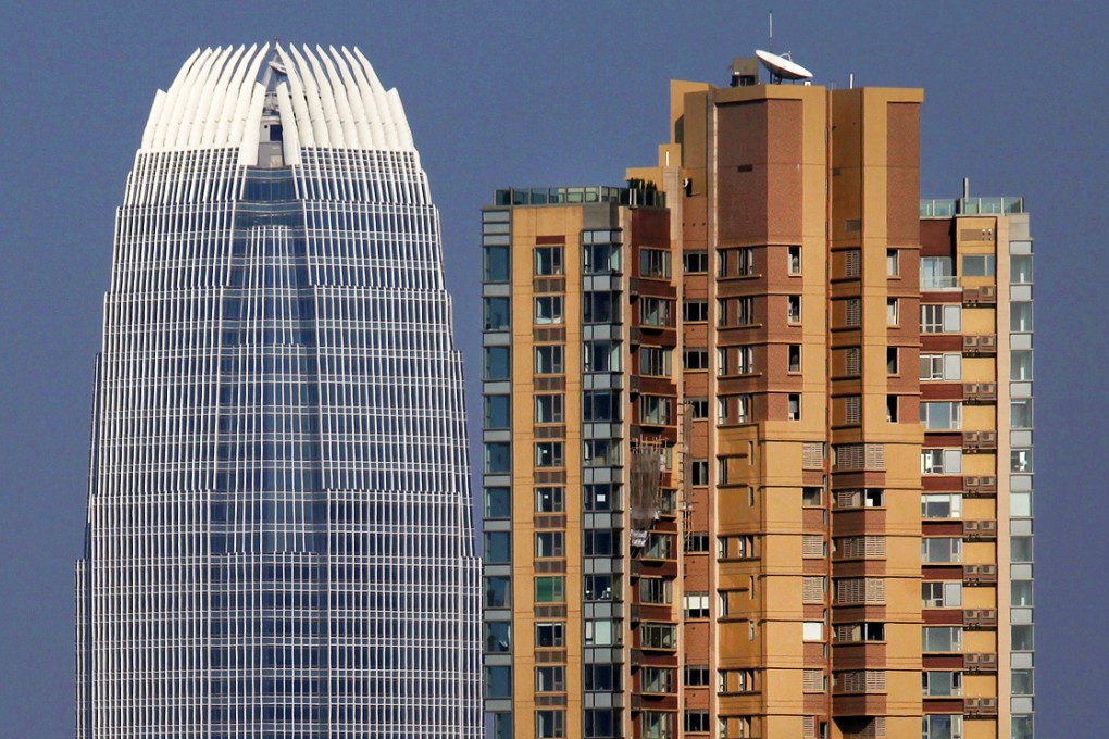 Two IFC (left) office building is seen next to the 39 Conduit Road, one of Hong Kong's most luxurious residential tower. Henderson sold a unit at 39 Conduit Road for HK$93,000 per square foot, which is a record for Asia. Photo: Reuters