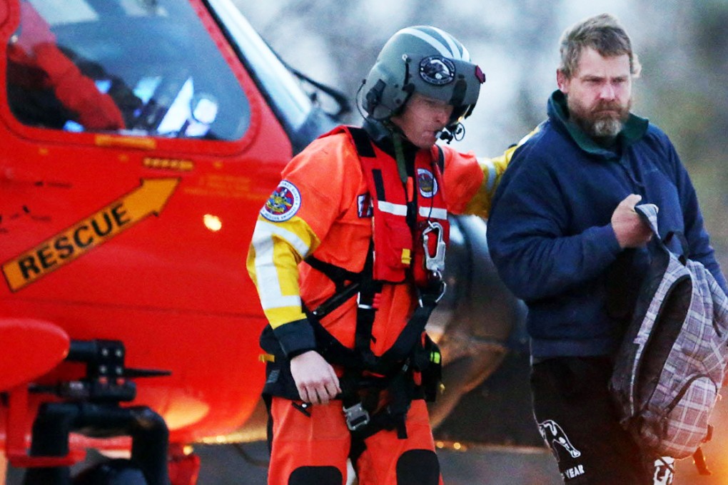 Louis Jordan (right) walks from helicopter to hospital. Photo: AP