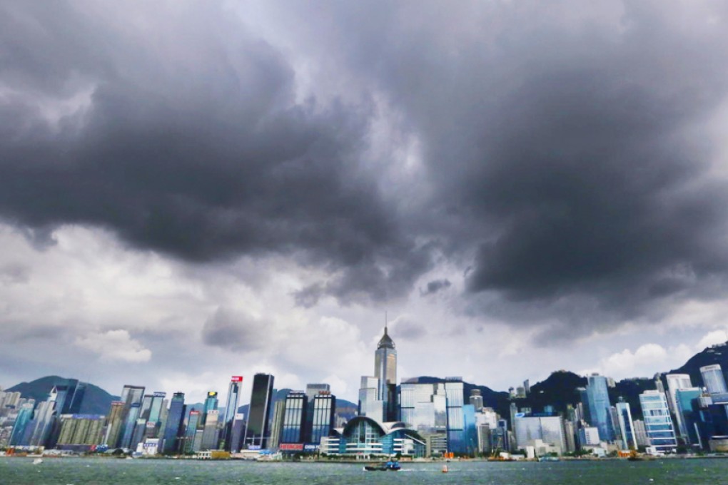 Storm clouds gather over the Hong Kong skyline as Typhoon Rammasun edged closer to the city in July last year – could Typhoon Maysak trigger the earliest storm signal warning since records began? Photo: Felix Wong