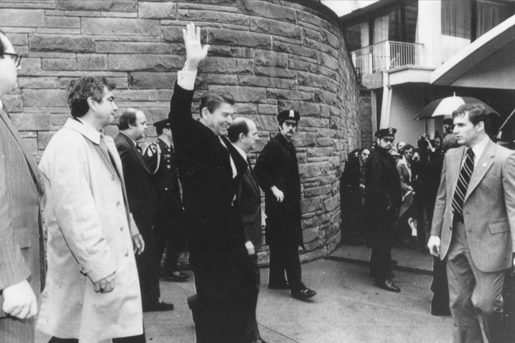 Ronald Reagan (above) waves just before being shot outside a hotel in Washington in 1981. James Brady is behind Reagan (second left) and with his wife, Sarah, (right) in Chicago in 1996.Photos: AFP, AP