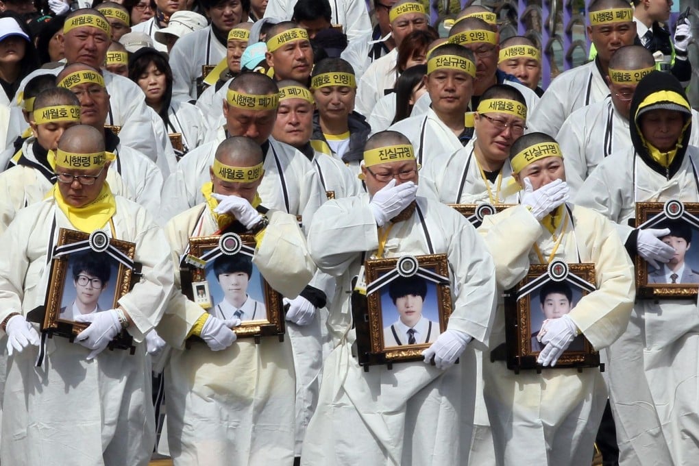 Grieving parents in white mourning robes and with shaved heads begin the march to press for an independent inquiry.Photo: AFP