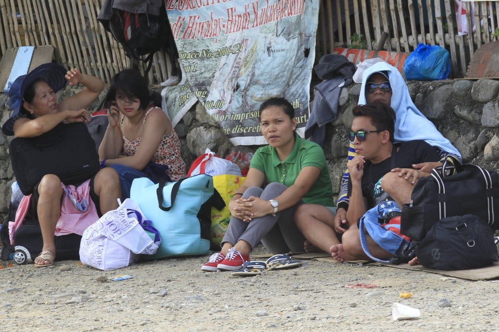 Stranded passengers wait outside of the port in Marinduque Island, central Philippines. Photo: Reuters