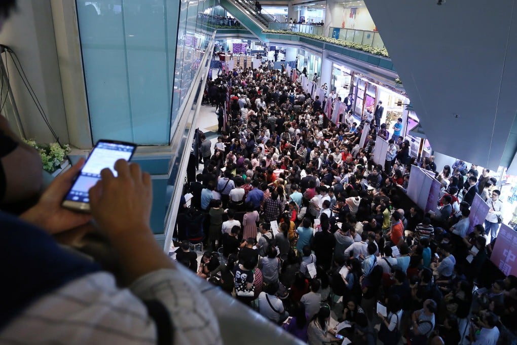 Thousands cram into Fortune Metropolis building in Hung Hom yesterday in a bid to buy a unit. Photo: Jonathan Wong