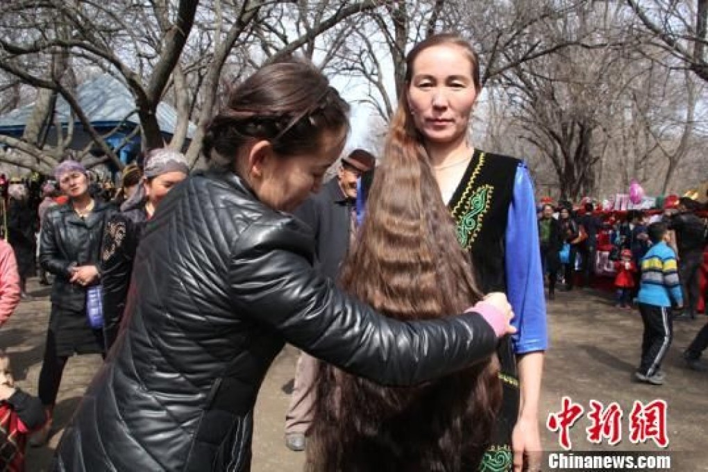 A competitor has her hair measured during the competition in Xinjiang province. Photo: China News Service
