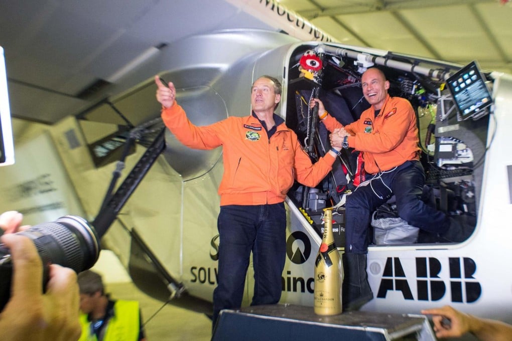 Pilots Andre Borschberg and Bertrand Piccard celebrate after the Solar Impulse 2 lands at Chongqing. Photo: Xinhua