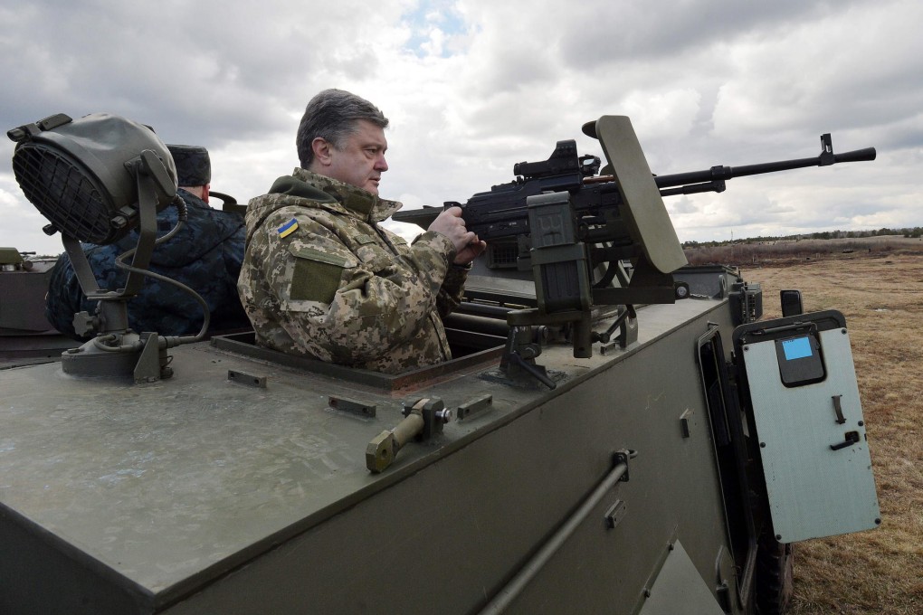 Ukraine's Poroshenko pictured last week examining a British-made armoured personnel carrier with a Ukrainian weapon system.Photo: AFP