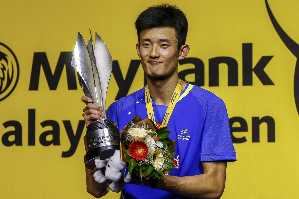 China's Chen Long shows off his trophy after winning the men's singles at the Malaysia Open. Photo: EPA