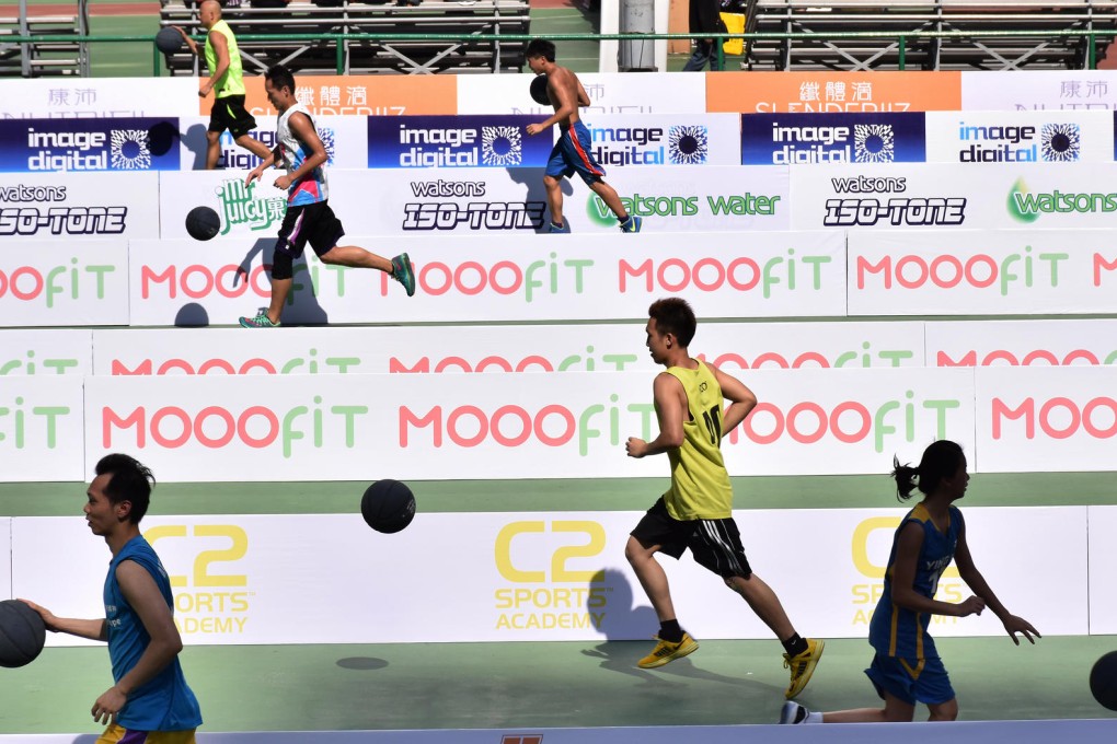 Participants race towards the basket to help beat the Guinness world record for basketball lay-ups in Southorn Playground, Wan Chai, yesterday. Photo: Franke Tsang