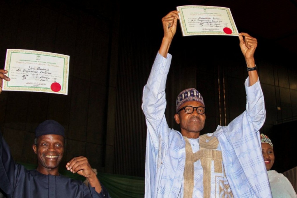 Nigerian President-Elect, General Muhammadu Buhari (right) and his Vice-President, Professor Yemi Osinbajo, display their Independent National Electoral Commission (INEC) certificates. Photo: EPA