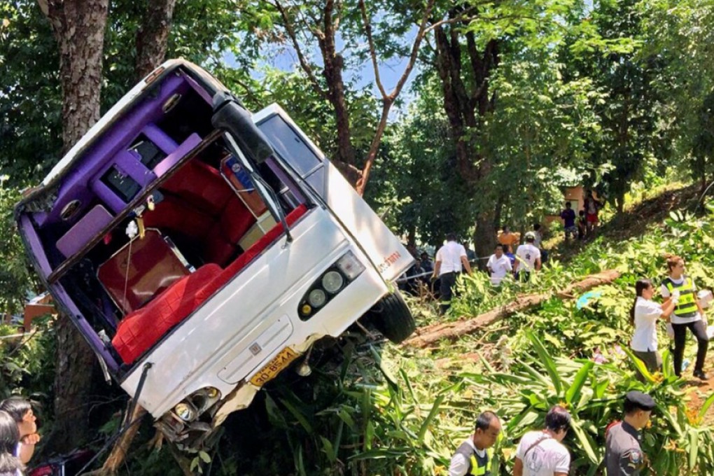 Thai rescue workers, medics and police officers inspect wreckage of a Chinese tourist bus at the accident scene in Phuket island. Photo: EPA