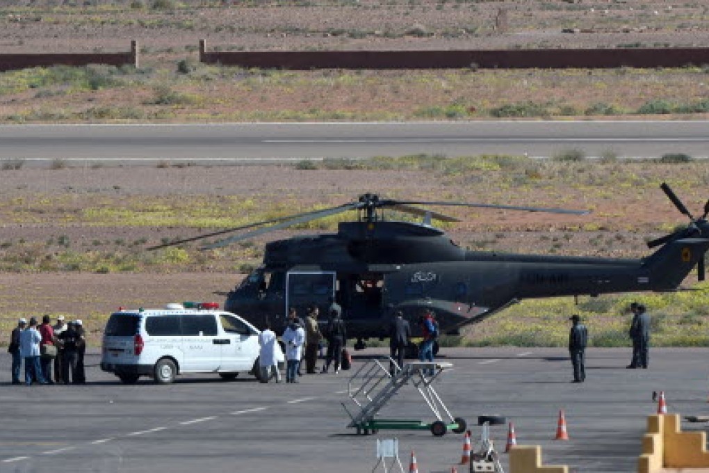 Members of Moroccan emergency services by their helicopter after the rescue operation for the Spanish cavers found in Morocco's High Atlas mountains. Photo: AFP