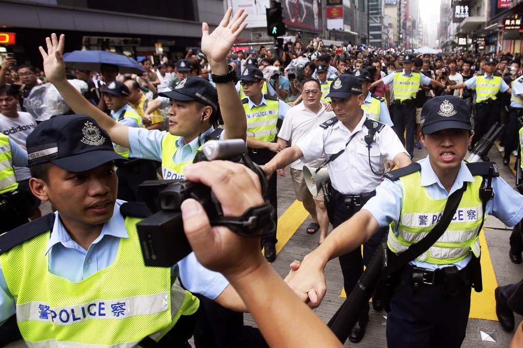 Police officers clear the occupied area in Mong Kok last year. An EOC survey last September found almost one in five employees had experienced discrimination in the workplace. Photo: EPA