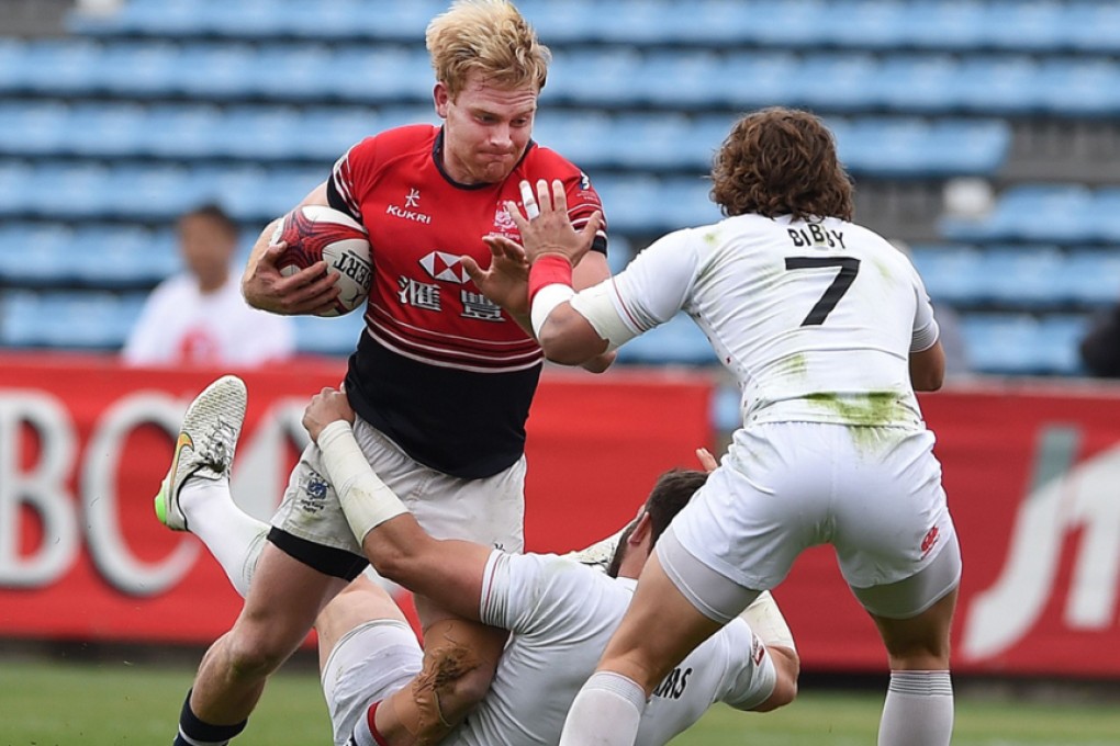 Hong Kong skipper Jamie Hood carries the ball into battle against England in their Japan Sevens pool clash at the weekend. Photos: AFP