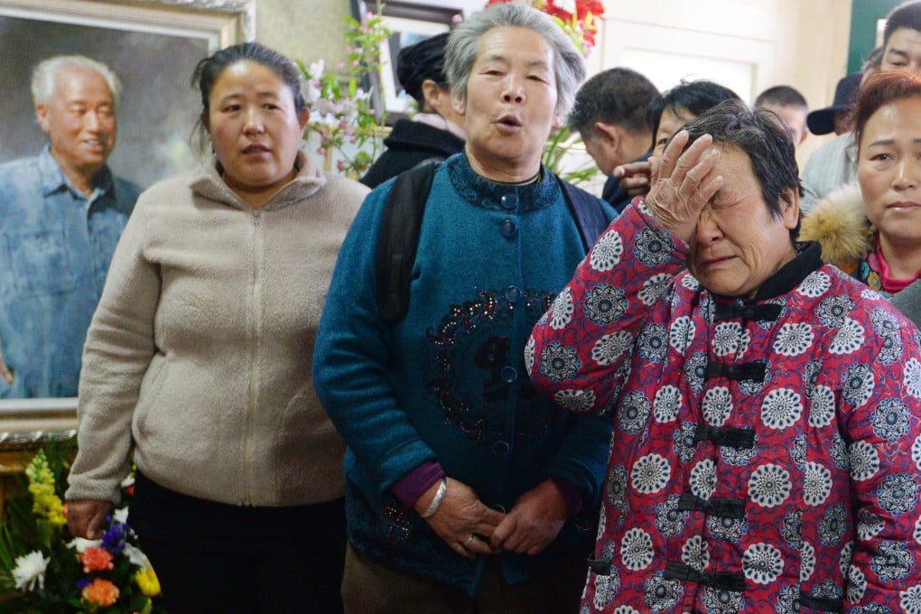 A woman weeps in front of a picture of Zhao Ziyang, the late general secretary of China's Communist Party, at Zhao's former home in Beijing on Sunday. Photo: Kyodo