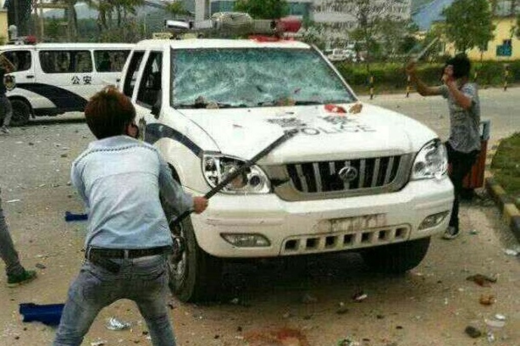 Three police cars were vandalised and flipped during the protest against the Langtang incinerator. Photo: SCMP Pictures