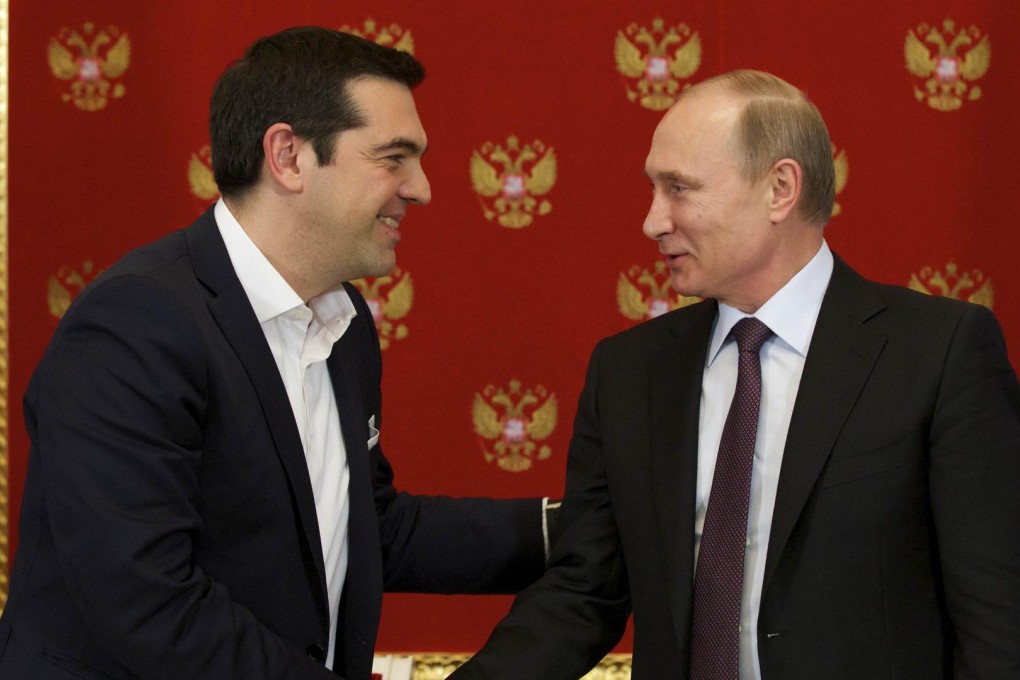 Alexis Tsipras shakes hands with Vladimir Putin. Photo: AFP