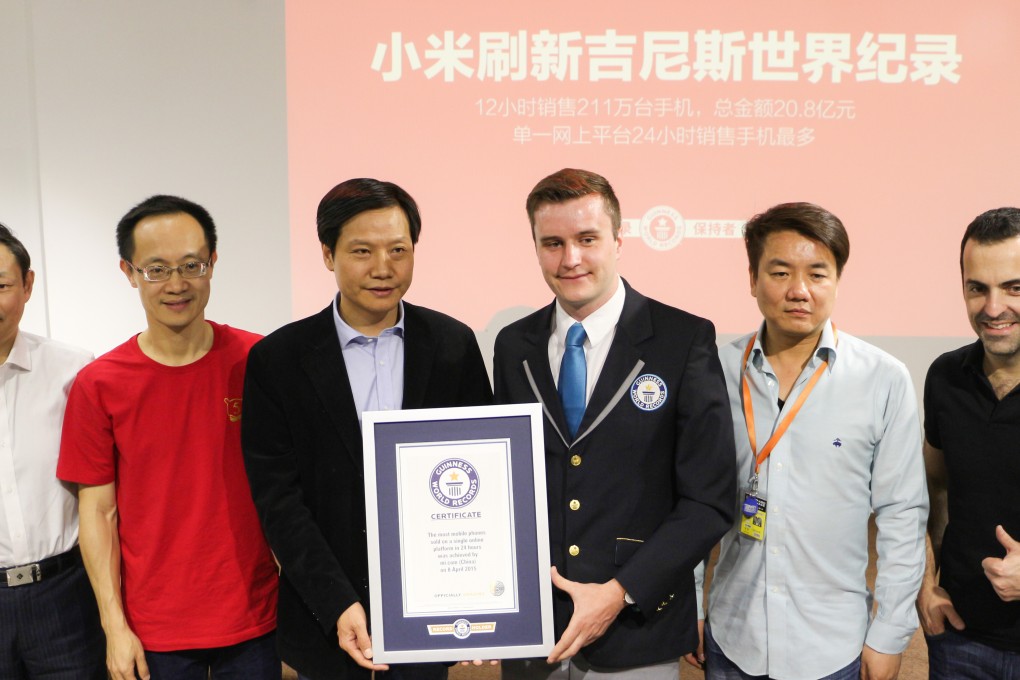 Xiaomi CEO Lei Jun and other senior staff pose with an official Guinness World Records certificate. Photo: SCMP Pictures