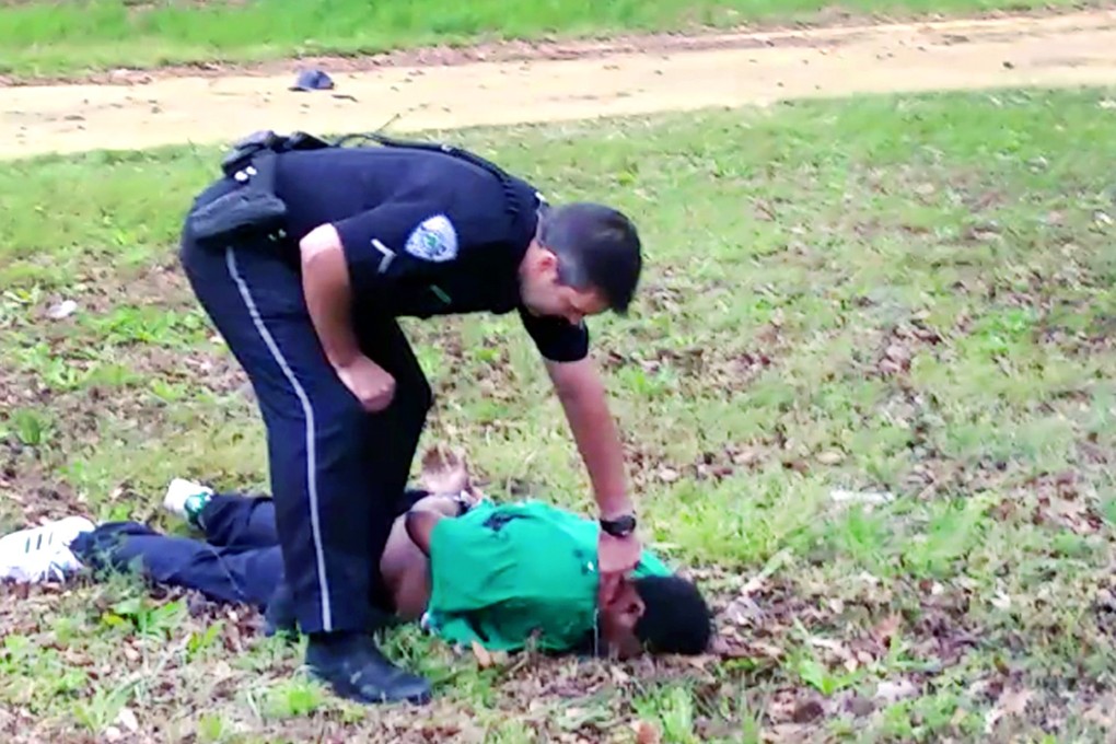 City patrolman Michael Thomas Slager checks Walter Scott's pulse after the shooting, in a frame from a video provided by the Scott family's attorney. Photo: AP