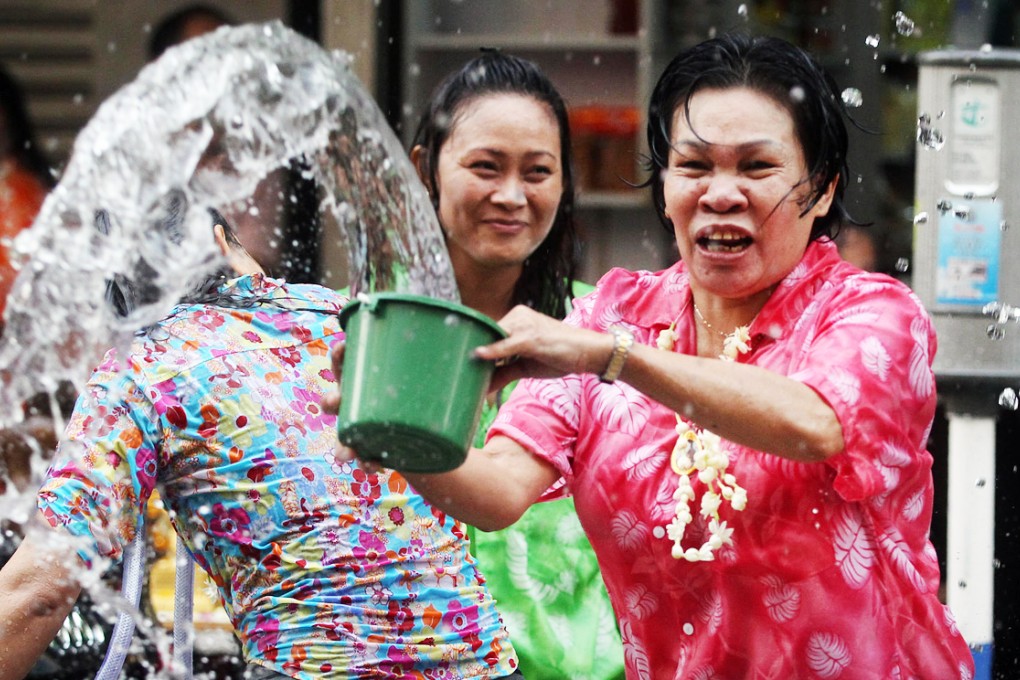 Revellers in Kowloon City douse a passer-by in water. Photo: K.Y. Cheng