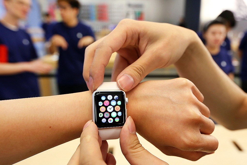 A customer tries on an Apple Watch at the Apple Store in Causeway Bay. Photo: Nora Tam