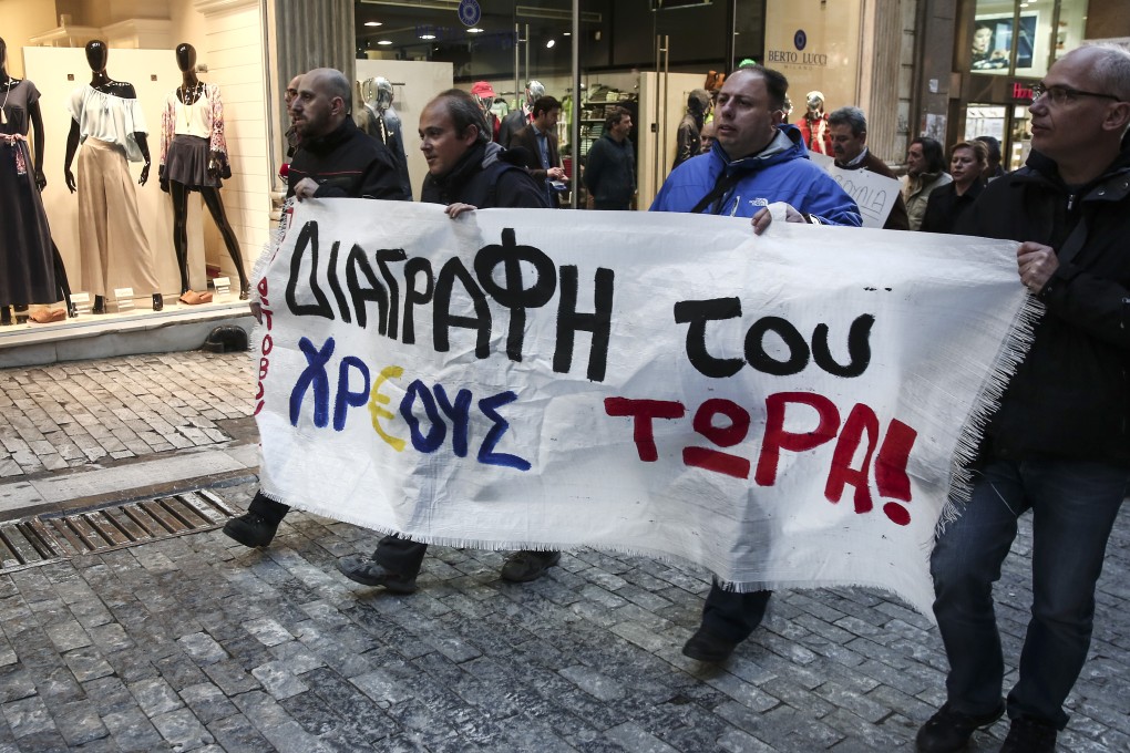 Demonstrators in Athens demanding the debt be written off as Greece repaid a loan instalment due to the IMF, easing concerns, for now, of a potential default. Photo: AP