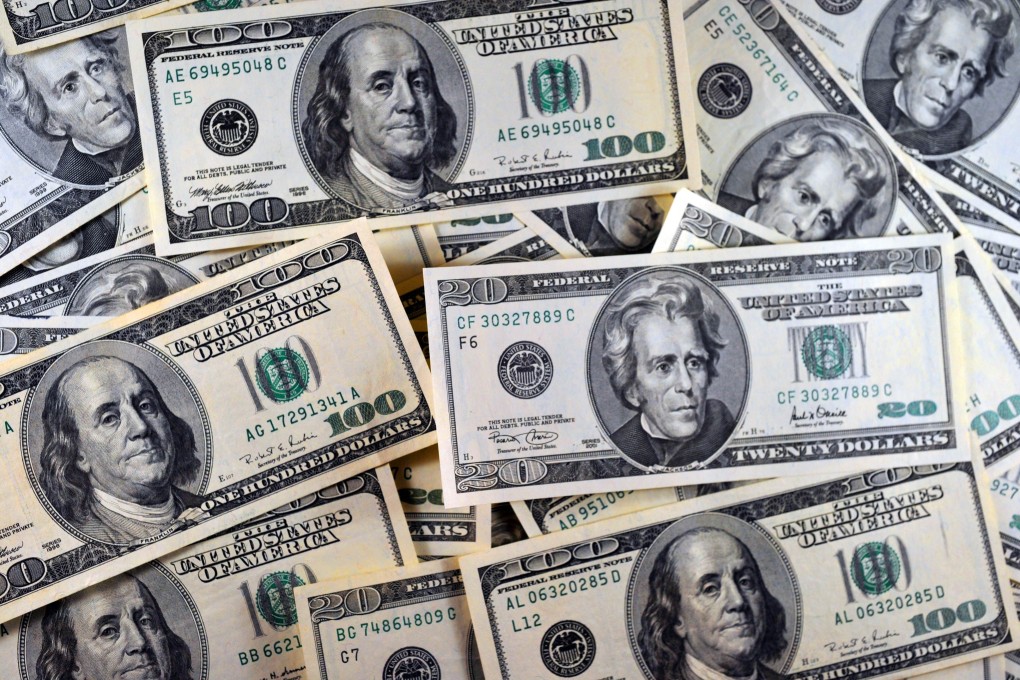 Dollar notes are scattered as the greenback recently hit 12 year highs. Photo: AFP