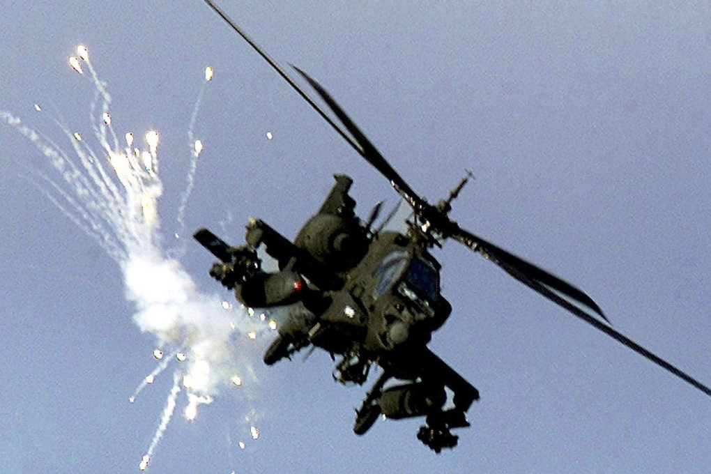 US Apache helicopter fires anti-missile flares. Photo: Reuters