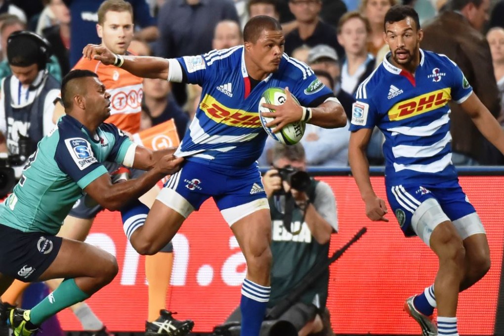 Juan de Jongh of Stormers is tackled by Waratahs utility back Kurtley Beale in Sydney on Saturday. Stormers were the first of three South African teams to beat Aussie opponents with their 32-18 victory at the Allianz Stadium. Photo: AFP