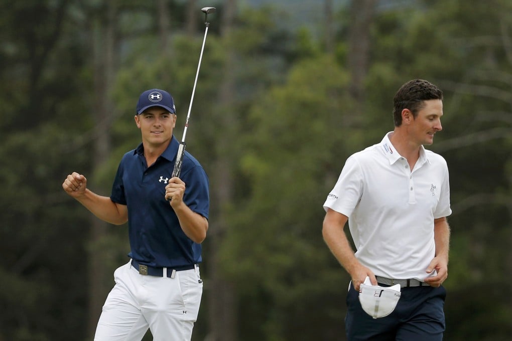 Jordan Spieth celebrates after sinking his putt on the 18th green to win the Masters as second-place finisher Justin Rose walks off the green. Photo: Reuters