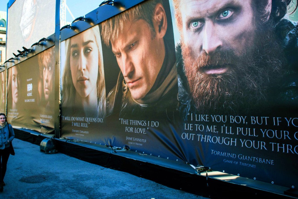 A woman walking past a poster of HBO American fantasy drama series Game of Thrones outside the International Game of Thrones exhibition in Stockholm. Photo: AFP