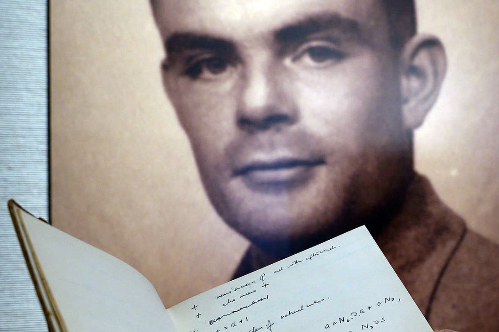 Pages from Turing's notes are seen with his portrait. Photo: AP