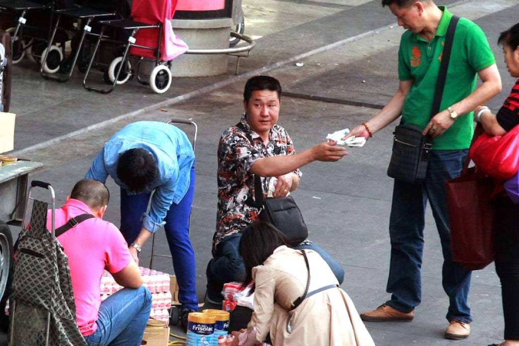 Merchants in Shenzhen serve a customer while in the midst of laying out their goods at a makeshift store yesterday. Photo: Dickson Lee