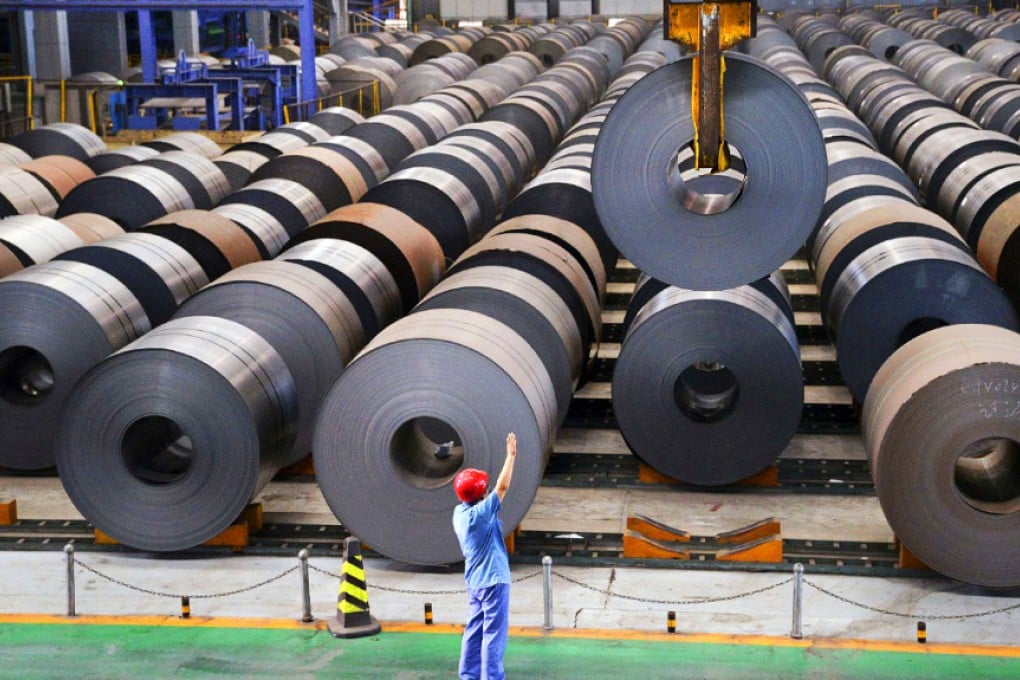 An employee guides a crane as it transports a roll of steel sheet, at a factory in Handan, Hebei province. March factory output rose 5.6 per cent from a year earlier. Photo: Reuters