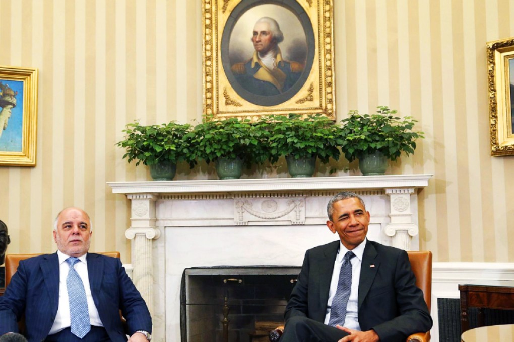 US President Barack Obama winks at reporters during a meeting with Iraq's Prime Minister Haidar al-Abadi in Washington. Photo: Reuters