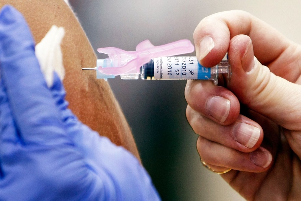 A dose of flu vaccination is administered during an exercise at TC Williams High School in Alexandria, Virginia. Photo: AFP