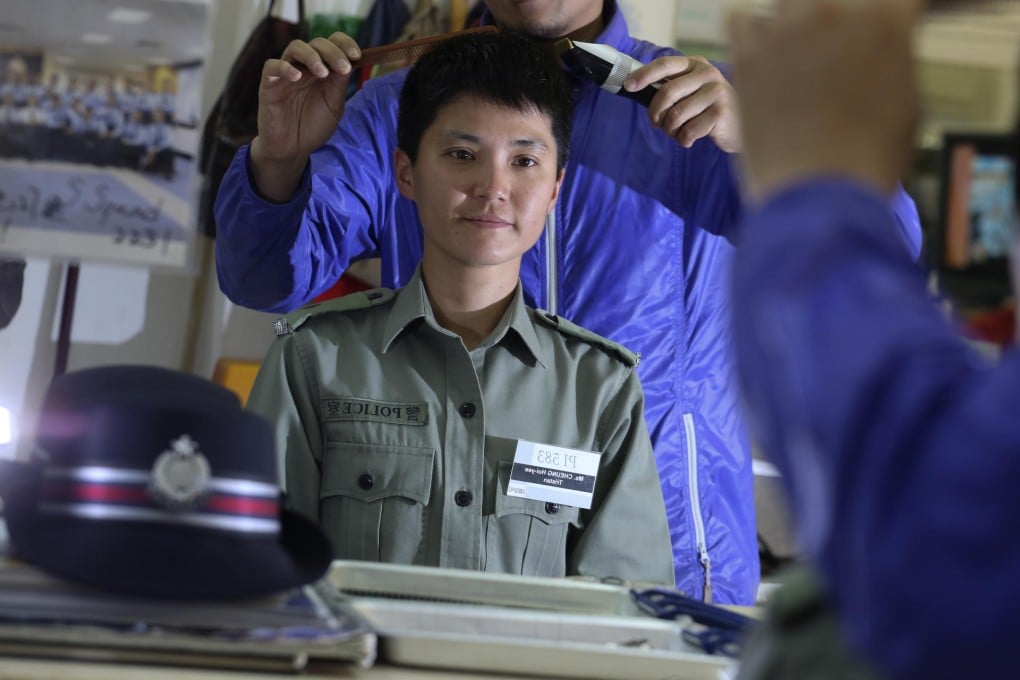 Police officer Tristan Cheung Hoi-yee loses her head of hair today in an effort to raise money for research into cures for childhood cancers. Photo: Felix Wong