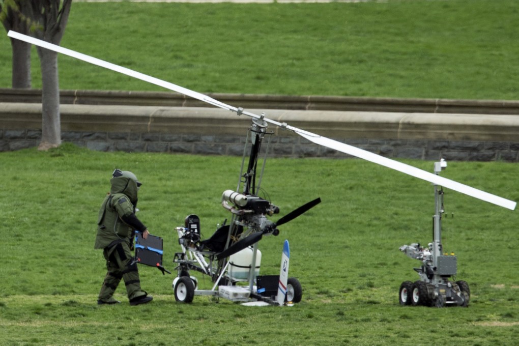 A bomb-disposal expert inspects the small helicopter that was piloted by Florida man Douglas Hughes. Photo: AP