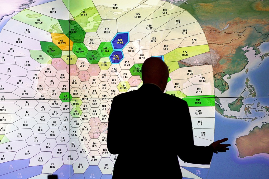 A member of staff at satellite communications company Inmarsat works in front of a screen showing subscribers using their service throughout the world, at their headquarters in London. Photo: Reuters