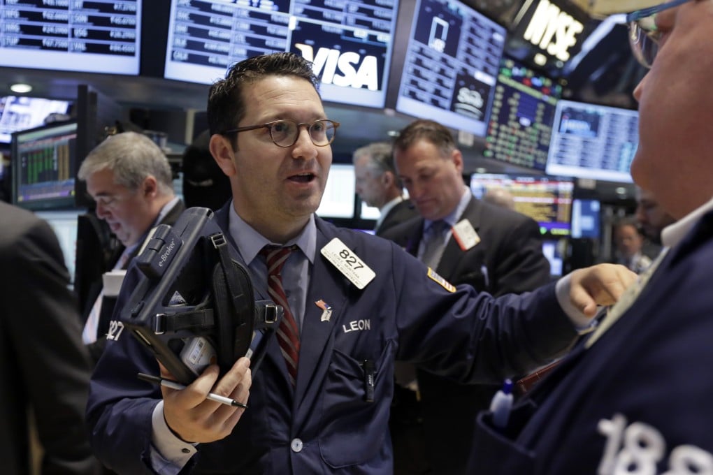 Floor traders on Wall Street take orders as US stocks climbed on strong corporate earnings. Photo: AP
