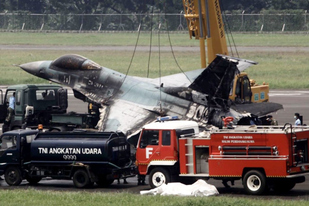 Indonesian Air Force members evacuate an F-16 fighter jet after an accident at Halim Perdana Kusumah Military airport in Jakarta. Photo: EPA