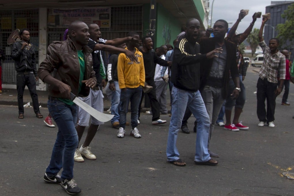 A group of foreign nationals prepare to defend themselves as police get between them and South Africans in Durban where at least four people have been killed in anti-immigrant violence.Photo: Reuters