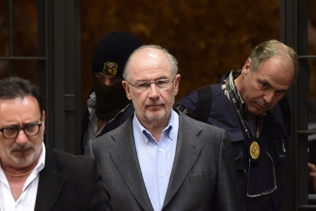 The case against ex-IMF head Rodrigo Rato (centre) could involve a contentious multimillion payment allegedly made to him by an investment bank. Photo: AFP