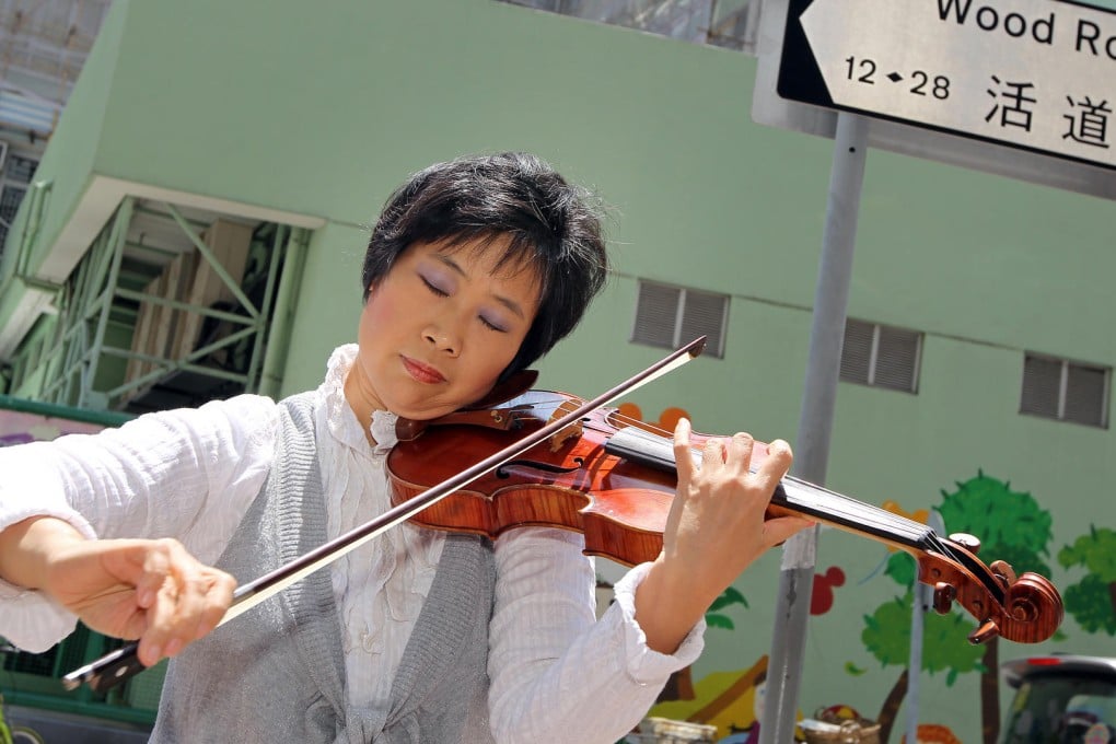 Ho Hong-ying, who plans to bring music to schools and elderly homes, gives an impromptu performance in Wan Chai. Photo: Franke Tsang